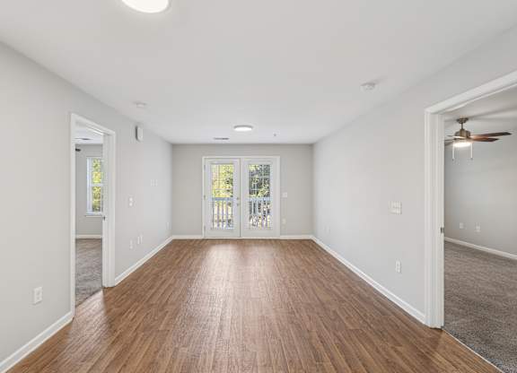 A room with wooden floors and white walls.