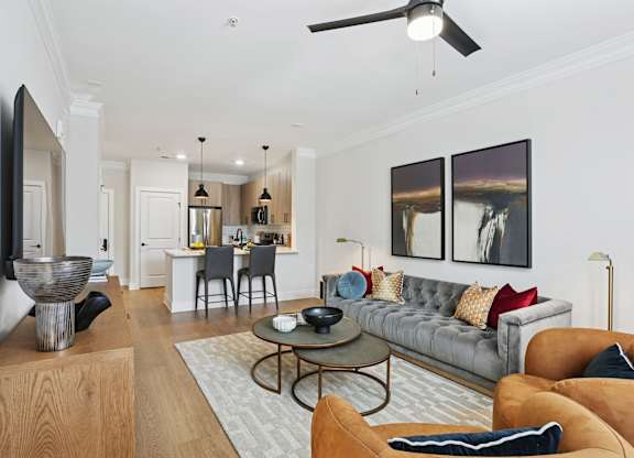 A living room with a grey couch and a coffee table at Union Eleven Apartments, Georgia 30324