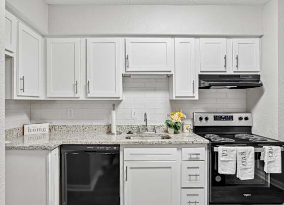 A kitchen with white cabinets and appliances.at Magnolia at Whitlock, Marietta, GA