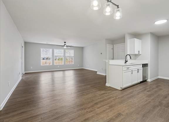 A kitchen area with a white cabinet and a fridge.