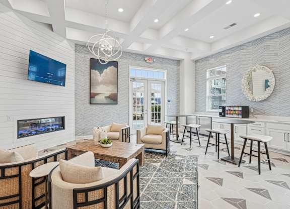 A modern living room with a fireplace and a flat screen TV.at The Parker Leland, Leland North Carolina