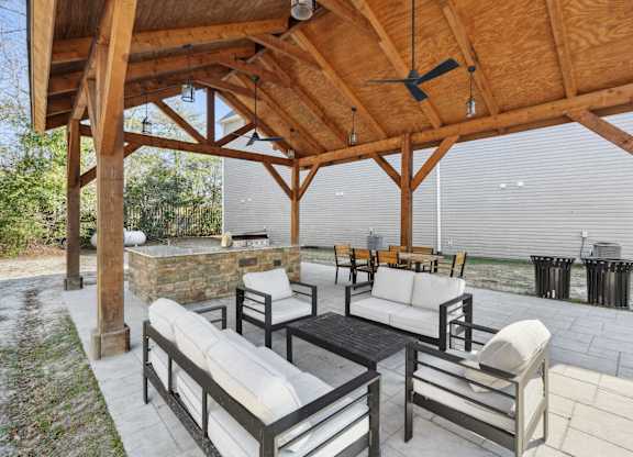 A wooden patio with a table and chairs.