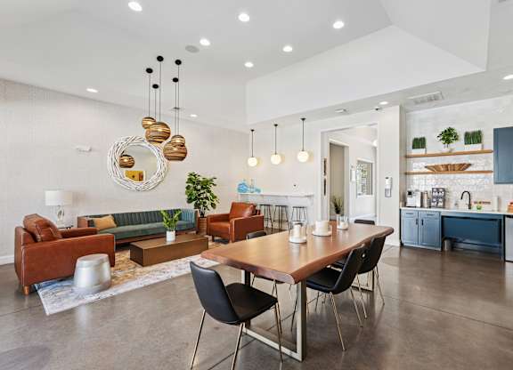 A modern living room with a dining table and chairs.