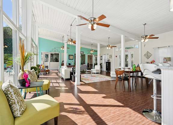 A sunny day in a spacious living room with a yellow sofa and a dining table.