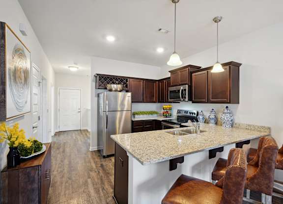 Kitchen with stainless steel appliances and a granite counter top at The Meadows, Bloomingdale, GA, 31302