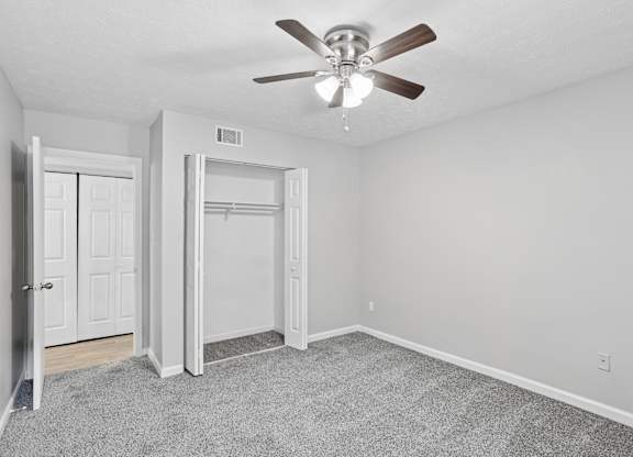 A room with a ceiling fan and a carpeted floor.at Magnolia at Whitlock, Georgia