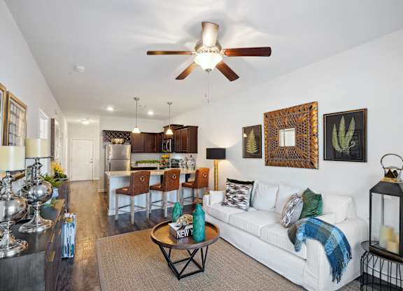 Living room with a white couch and a ceiling fan  at The Meadows, Bloomingdale, Georgia