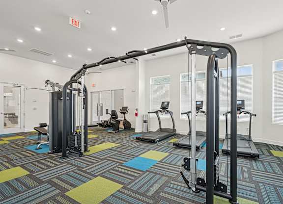A gym with a variety of equipment including treadmills and weight machines.at The Parker Leland, North Carolina, 28451
