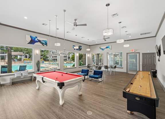 A room with a pool table and a ping pong table.
