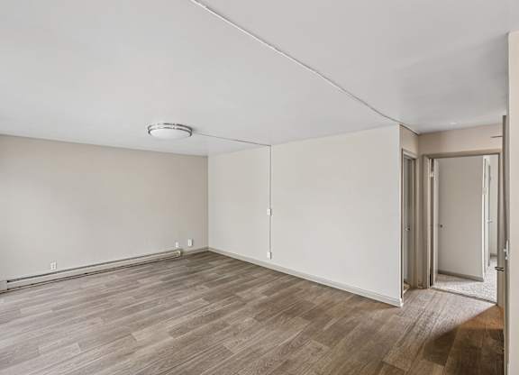 A room with light brown floor and white walls at Madison Flats, Madison