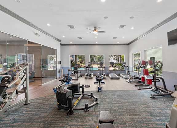 A gym with a variety of exercise equipment.