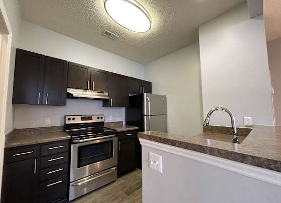 Kitchen with stainless steel appliances and granite counter tops at The Chase, North Carolina