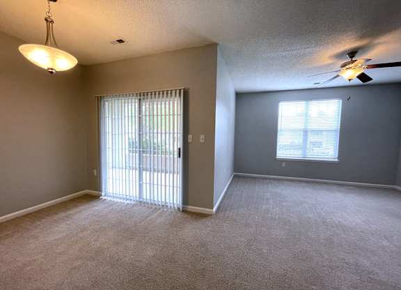 Living room with a window and a ceiling fan at The Chase, Burlington