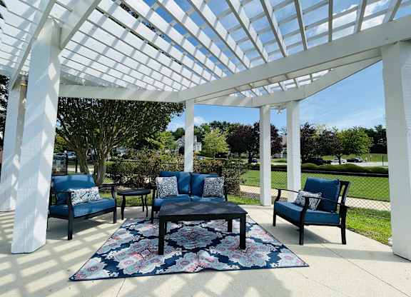 Covered patio with chairs and a table at The Chase, Burlington, NC 27215