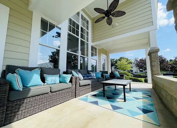 Covered porch with couches and a coffee table at The Chase, North Carolina