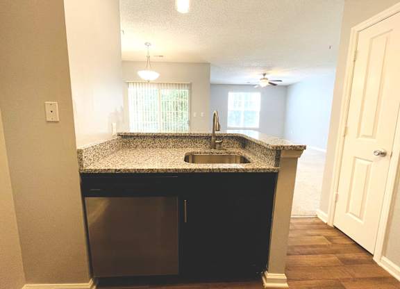 Kitchen peninsula with a sink and a counter top at The Chase, North Carolina, 27215