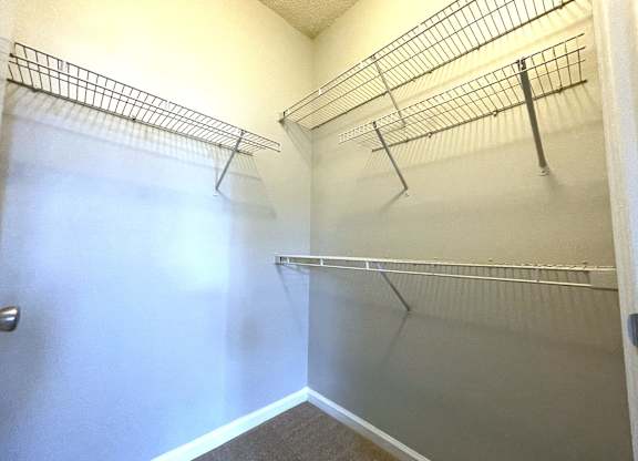 Walk in closet with shelves and a white wall at The Chase, Burlington North Carolina