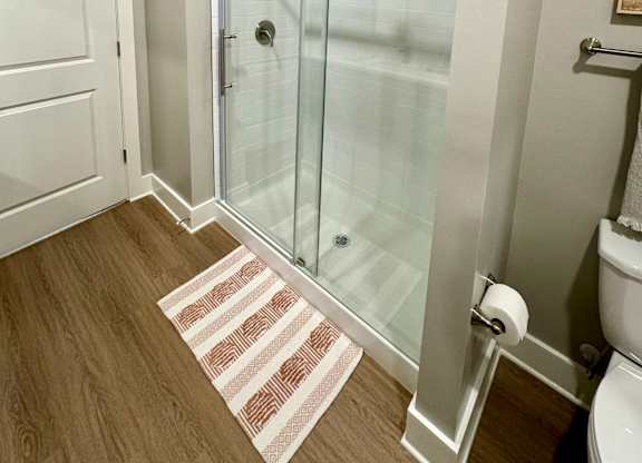 A bathroom with a walk-in shower and a toilet at The Collective Upper Westside Apartments, Atlanta, GA, 30318