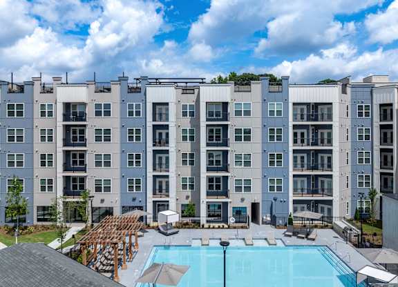 A large apartment complex with a pool in the courtyard at The Collective Upper Westside Apartments, Georgia