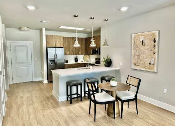 A kitchen with a table and chairs at The Collective Upper Westside Apartments, Atlanta, 30318