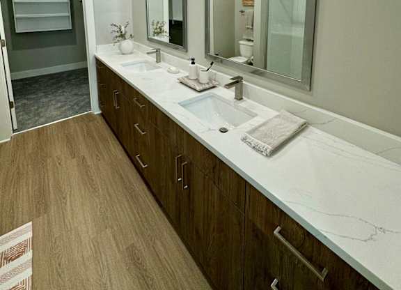 A bathroom with a white sink and a large mirror at The Collective Upper Westside Apartments, Atlanta, GA