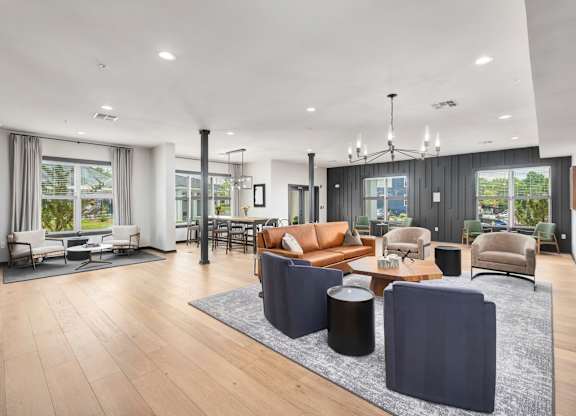 A modern living room with a large sectional sofa and a coffee table at The Percy Apartments, Nashville, TN