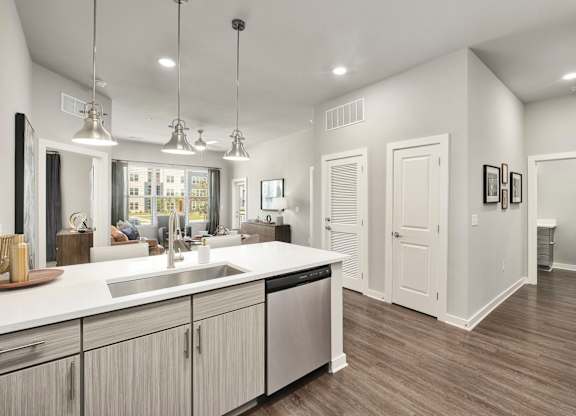 A modern kitchen with a large island and stainless steel appliances at The Percy Apartments, Nashville
