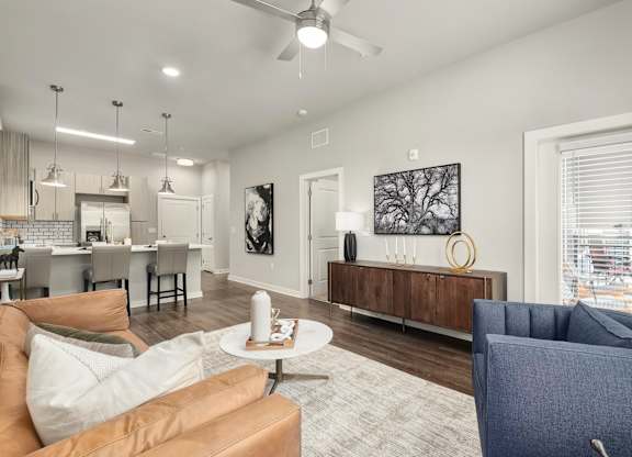 A living room with a brown couch and a white coffee table at The Percy Apartments, Nashville, TN