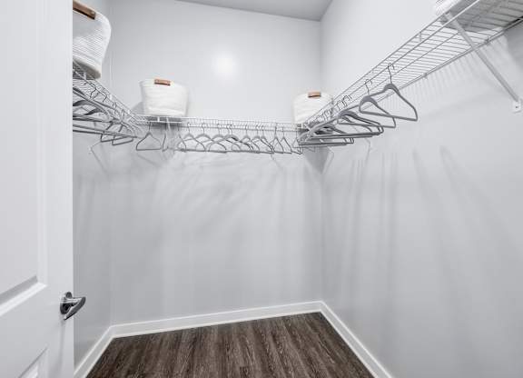 A white closet with a wooden floor and a white door at The Percy Apartments, Tennessee, 37214
