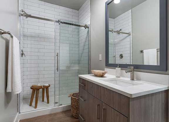 A bathroom with a white sink and a mirror at The Waverly at Winter Haven Apartments, Winter Haven, FL, 33884