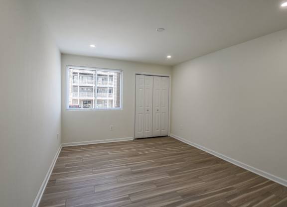 A room with a wooden floor and a window.