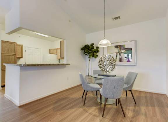 a dining room with a table and chairs and a kitchen