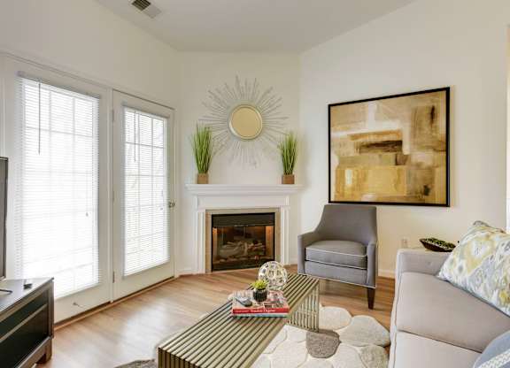 a living room with a couch and a chair and a fireplace