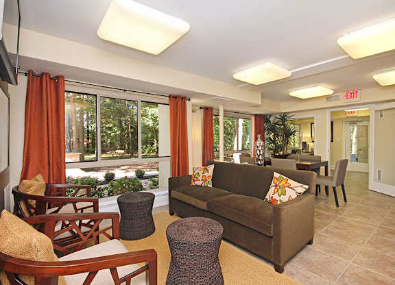 A living room with a brown couch and a flat screen TV.
