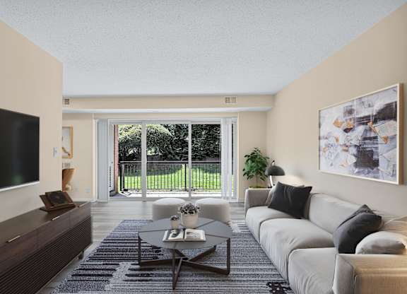 A modern living room with a flat screen TV on the left and a large window with a view of a green lawn outside.