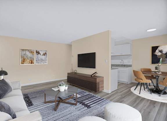 A living room with a grey sofa, a coffee table, and a television.