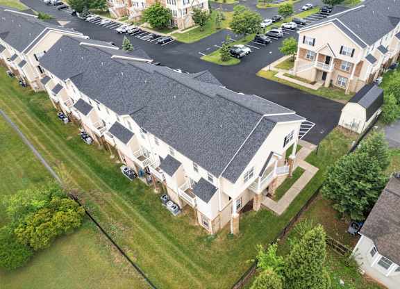 A bird's eye view of a residential area with houses and cars.