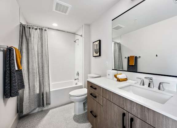 A bathroom with a white toilet, a white sink, and a white bathtub.