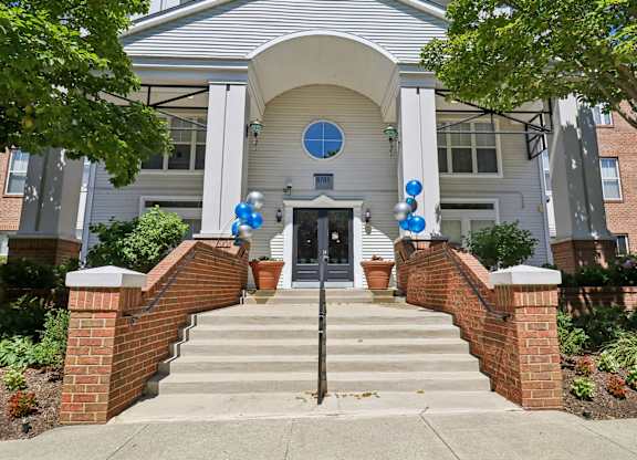 A house entrance with a brick wall and steps.