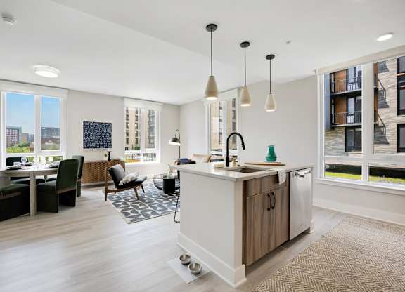 A modern kitchen with a dining table and chairs.