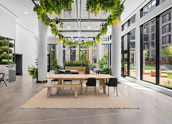 A modern dining area with a long table and chairs.