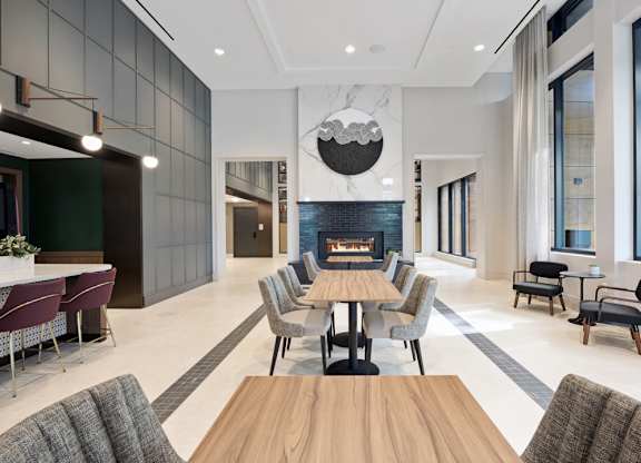 A modern dining room with a wooden table and chairs.