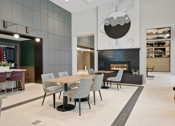 A modern dining room with a fireplace and a TV.