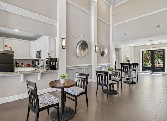 A dining room with a table set for four.