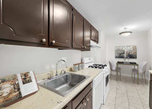 A kitchen with brown cabinets and a white sink.