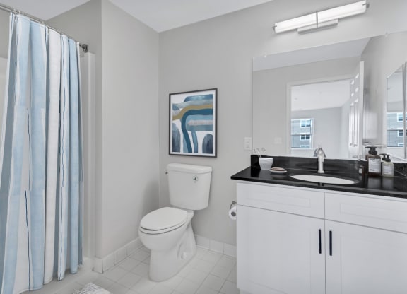 a bathroom with a toilet and a sink and a shower