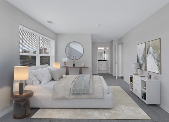 a bedroom with a bed and a mirror in a white room