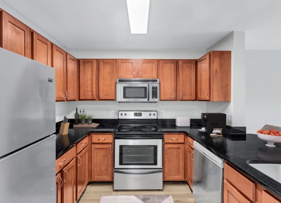 a kitchen with wooden cabinets and stainless steel appliances