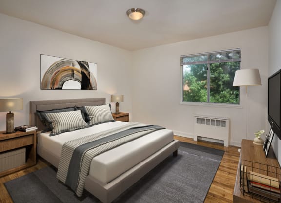 a bedroom with a white bed and a tv