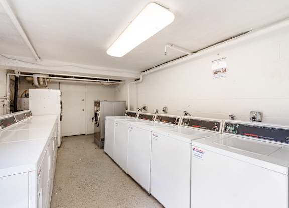A laundry room with washers and dryers.